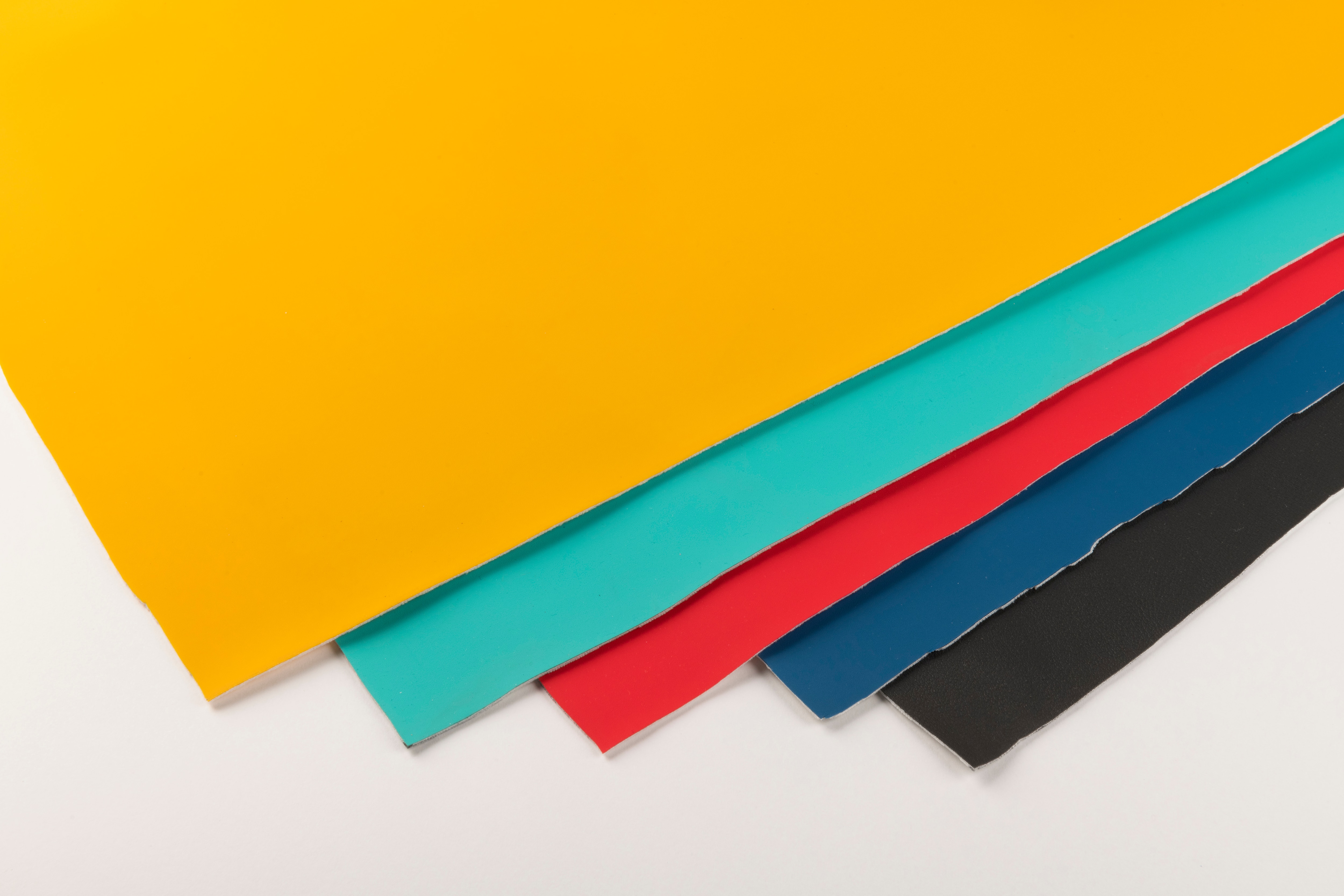 5 swatches of synthetic leather in yellow, teal, red, dark blue and black 
