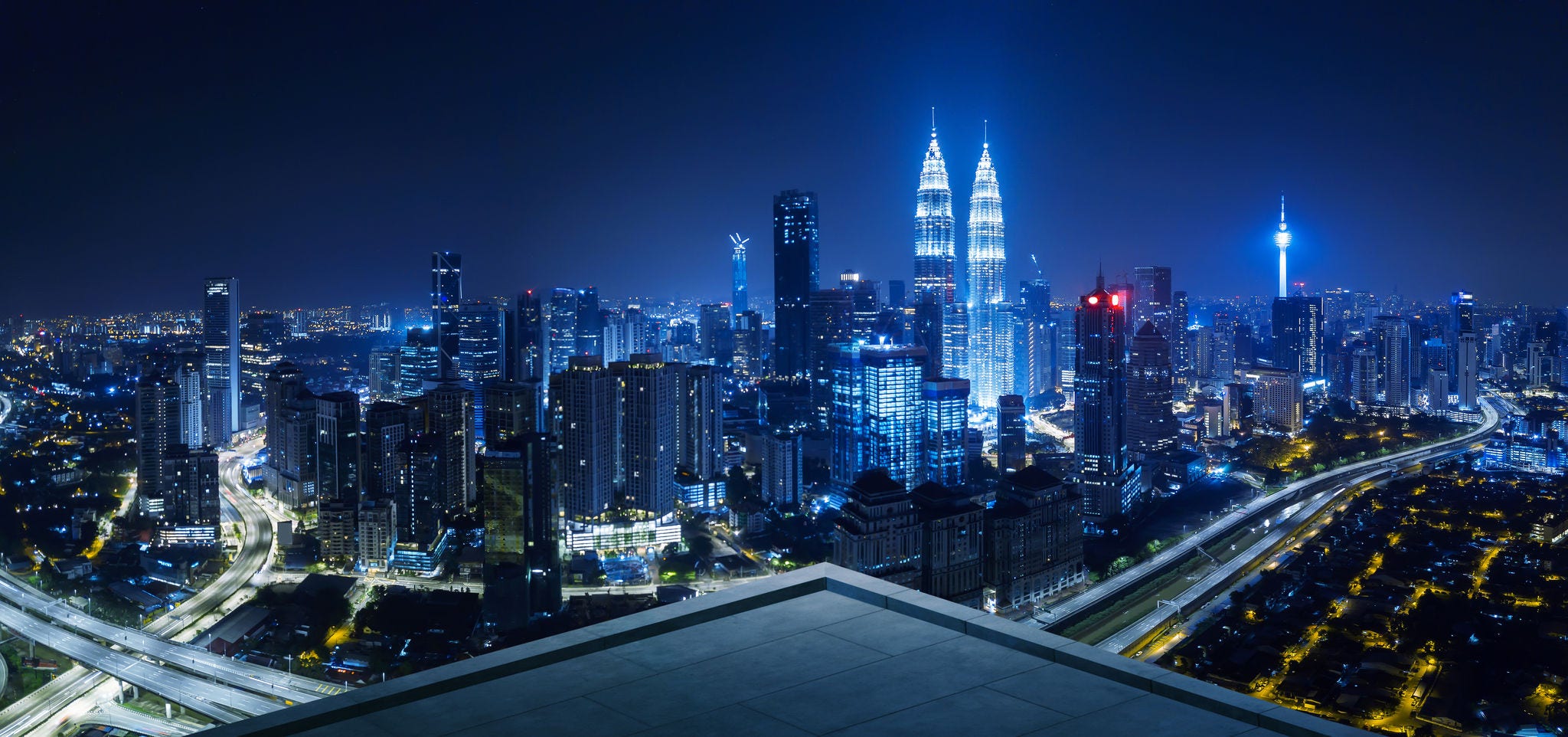 View from rooftop balcony of Kuala Lumpur cityscape skyline at night